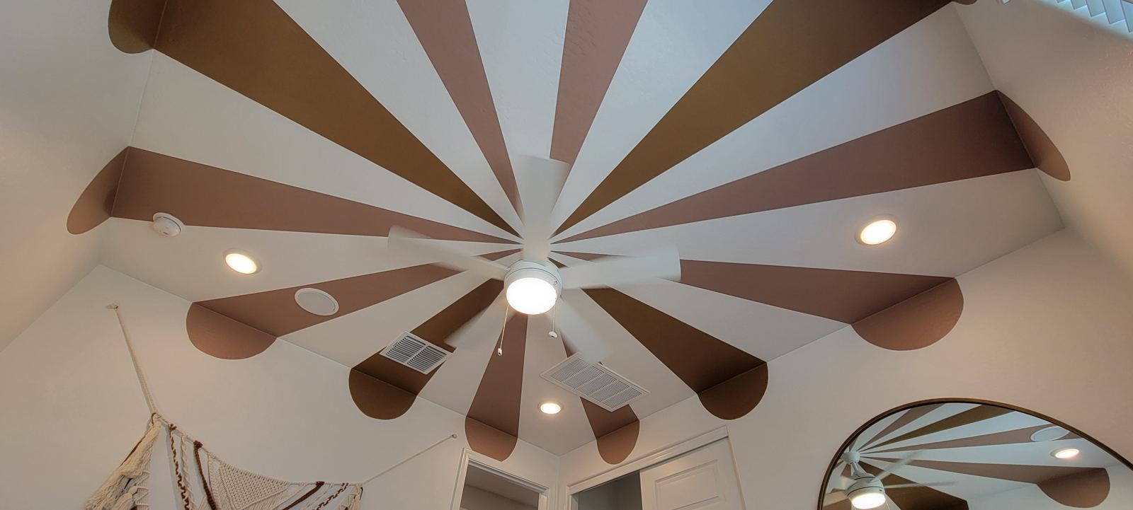 Sunburst ceiling paint around a fan
