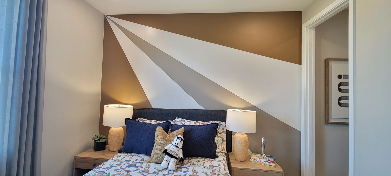 Geometric ray accent wall behind a bed